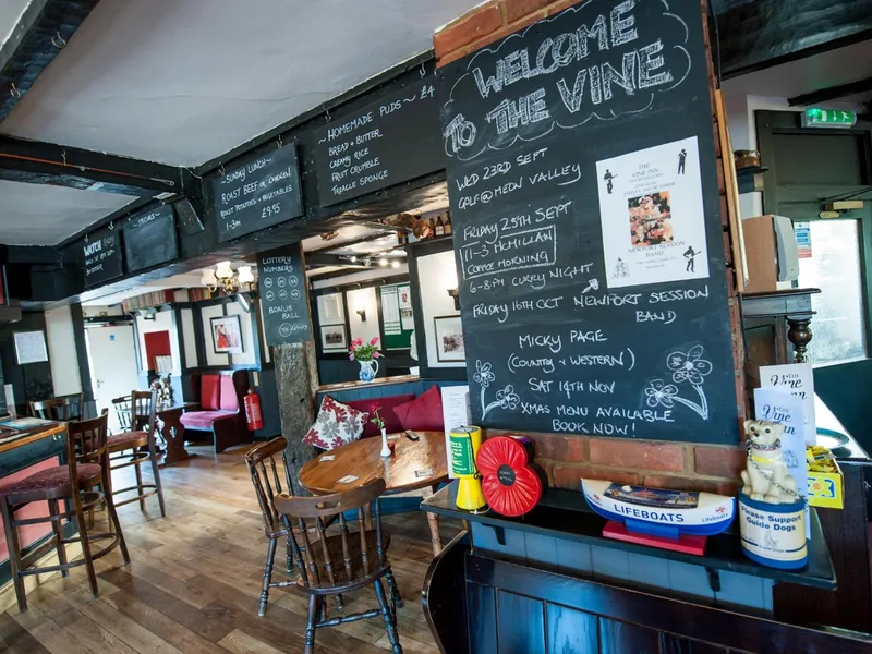 Interior seating and notice boards at The Vine Inn in Bursledon